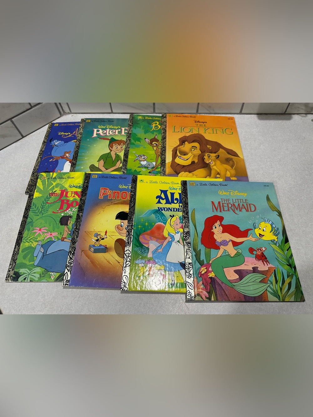 The product is a collection of 8 Disney Little Golden Books from classic films